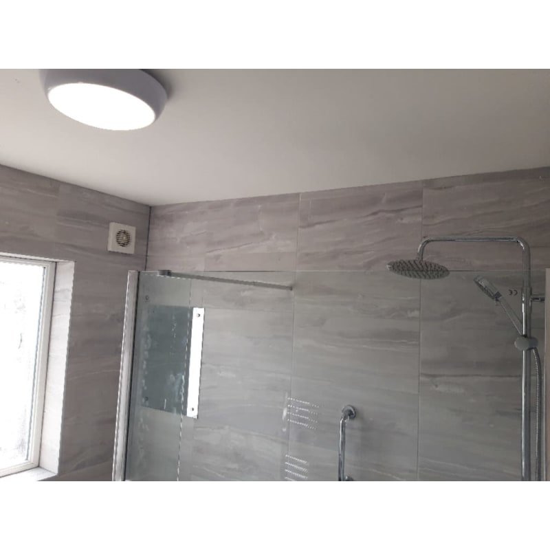 bathroom tiling with shower head fitting